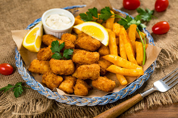Crispy Fish Bites Snack Size. Deep Fried Pollock Fish Fingers with Tartar Dipping Sauce. Selective focus.