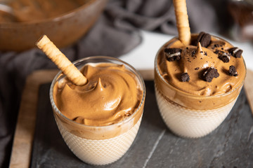 Two glass cups with Dalgona frothy coffee trend korean drink latte espresso with coffee foam