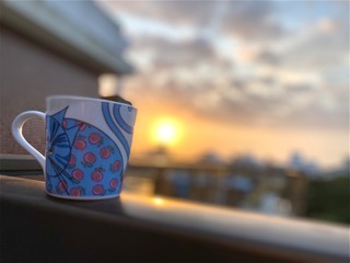 a cup of coffee at the dawn. Blue cat in the balcony