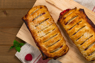 Puff Pastry Fruit Berry Strudel on Wooden Background. Selective focus.
