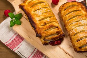 Puff Pastry Fruit Berry Strudel on Wooden Background. Selective focus.