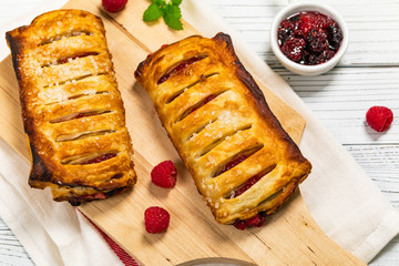 Puff Pastry Fruit Berry Strudel on Wooden Background. Selective focus.