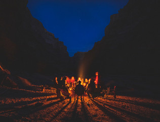 people sitting around campfire