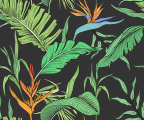 Seamless pattern with tropical flowers and palm leaves on a dark background