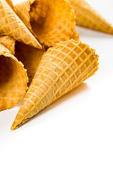 Empty Waffle Cone. Waffle Ice Cream Cones on White Background. Cone Shaped Pastry. Selective focus.