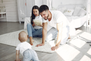 Obraz premium Cute family in a room. Lady in a white shirt. Little boy with parents