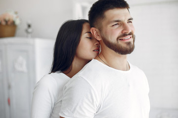 Obraz premium Cute couple in a bedroom. Lady in a white shirt. Pair at home
