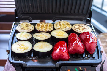 paprika and eggplant cooking on electric grill