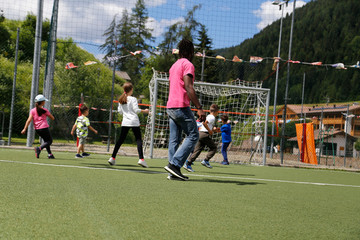 little children play football under the supervision of an animator. Children playing Football at...