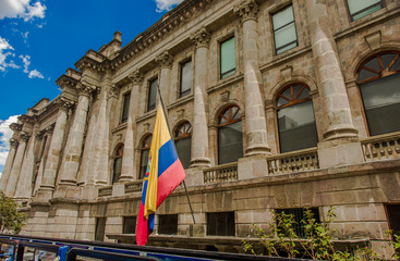 QUITO, ECUADOR - SEPTEMBER 10, 2017: Beautiful view of colonial buildings with an Ecuadorian flag hanging from the balcony located in the city of Quito