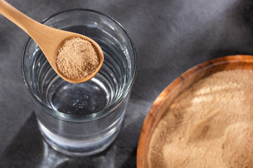Lepidium meyenii - Spoon with organic maca and glass of filtered water