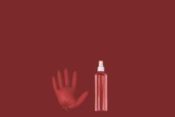 A medical glove and a a bottle of transparent sanitizer with outer place