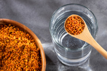 Spoon with bee pollen grains to mix with water