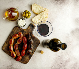 roasted spanish sausages on the cutting board - butifarra blanca, chorizo, morcilla de cebolla,...