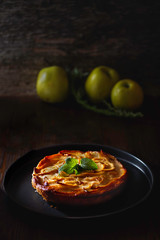 apple pie on a rustic background in a dark environment