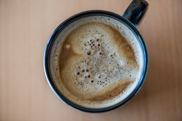 Close up of a espresso coffee with a heart on wooden background