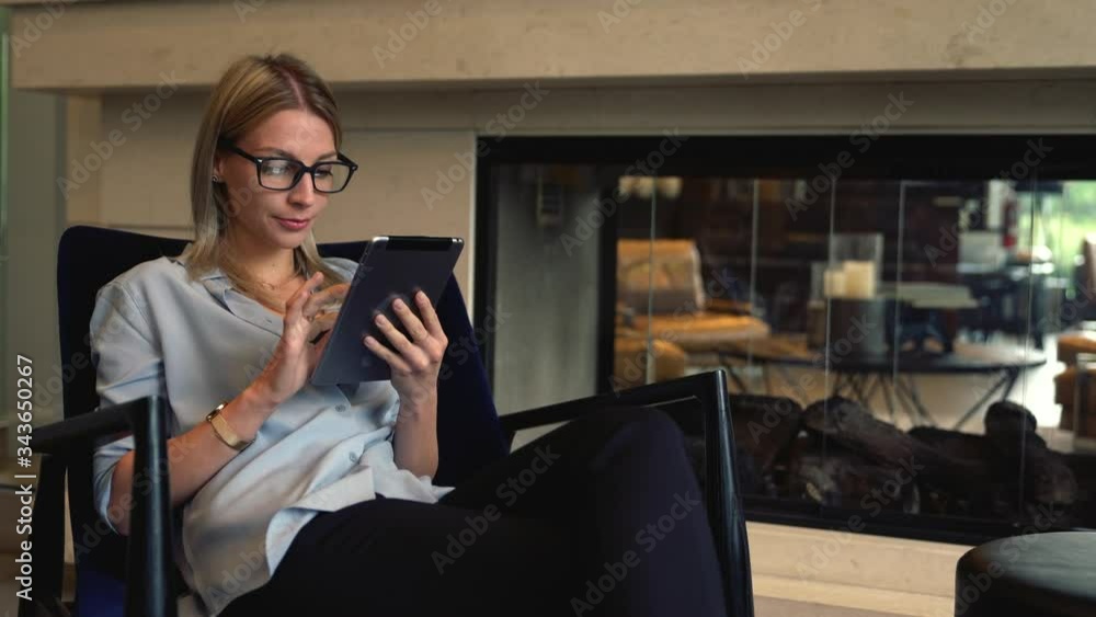 Aufkleber millennial woman in optical spectacles sitting in lobby and reading received text message from frien