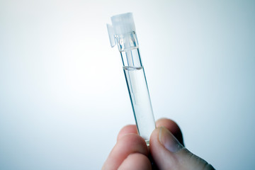 Fingers holding fragrance vial