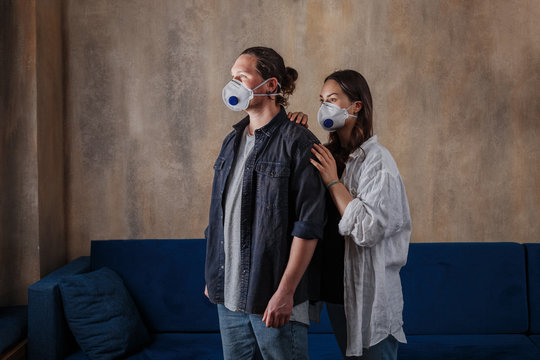 Couple in love, man and woman in protective medical mask on face at home. Environmental pollution concept. Guy, girl against Chinese pandemic coronavirus, virus protection