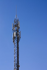 Mobile phone antenna with a clear blue sky in the background
