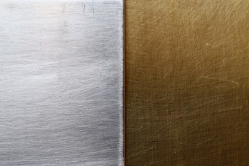 Two different textures of steel and bronze or brass, bisected background