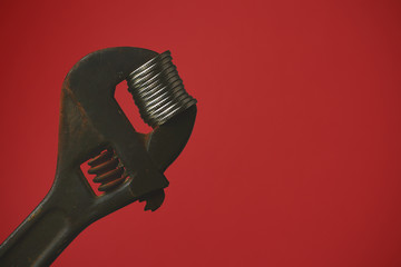 Adjustable wrench compresses coins with copy space for inscription or text, toned