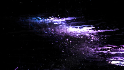 Water splashing in a fountain with colorful light. Neon purple colors glowing in the dark abstract background with copy space