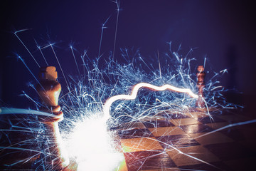 Chess king on fire and sparks. Low key. Toned. Abstract metaphor of confrontation on the example of...