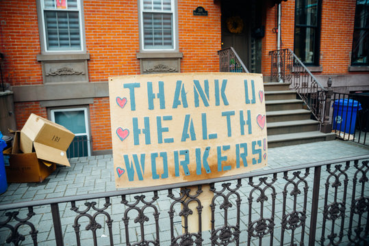 Hoboken, NJ - April 27 2020: A sign in the street in front of a brownstone that reads thank u healthcare workers you raising spirits Coronavirus COVID-19 pandemic epidemic fighting 