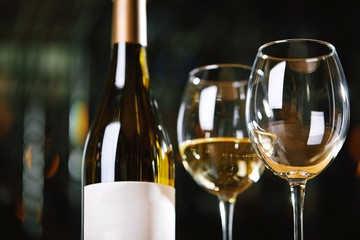Bottles and glasses with wine on the table. Wine drinking culture concept. Apperetes and survivors. Copy space, dark background