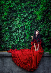 Naklejka premium Beautiful girl with long hair in red dress