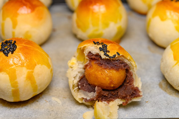 fresh homemade traditional chinese snack of preserved egg cakes with one piece cut out close up