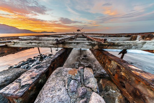 Sunset at Taltal pier with the fishing boats trying to go with the horizon line, Antofagasta in Chile. Niter was the main business of this area in North Chile, Atacama Desert, Chile
