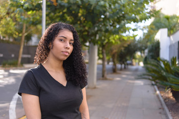 Black woman on urban background in casual clothing