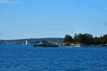 A ferry cruises across Sydney Harbor after pulling out from Rose Bay Wharf