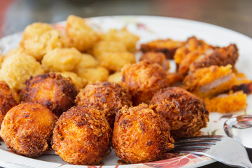 delicious cheese ball fried with chicken nugget on white disc ready eat