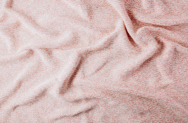 Pink knited cotton plaid. Top view. Cozy sleep concept