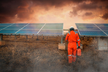 Engineers hold a tool for checking the performance of the solar panel to confirming systems working normally. Photovoltaic module idea for clean energy production