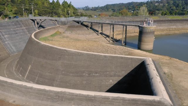 Nihotupu Dam, Auckland, New Zealand, 2020. Aerial flying over dried water reservoir and spillway at a low level because of a drought