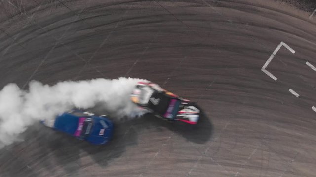 Black and blue cars drifting