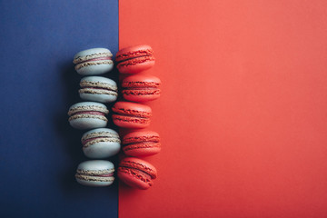 french strawberry red and blueberry blue macaroons on a colorful background
