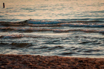 Waves of Lake Michigan on the beach at sunset in South Haven Michigan