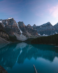 Beautiful Moraine Lake in Banff National Park during Dusk with Beautiful Landscape, Calm Waters and Reflection in the Water  