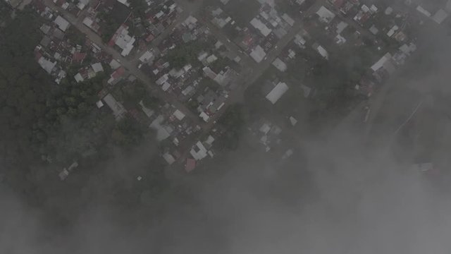aerial view of a rural mountain town through the clouds
