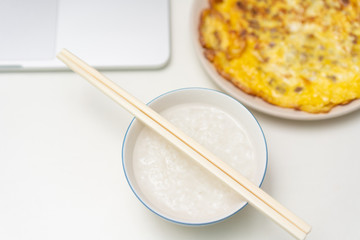 Chinese breakfast placed in front of computer desktop