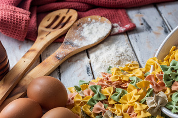 
dry pasta on rustic wood and fresh eggs