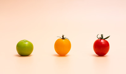 Virgin fruit and green plum laid out on orange background