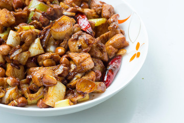 Homemade Chinese cuisine kung pao chicken in white plate with white background
