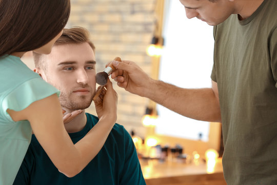 Professional makeup artist teaching trainee in salon. Apprenticeship concept
