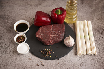  Beef with spices, garlic, pepper and chopsticks.